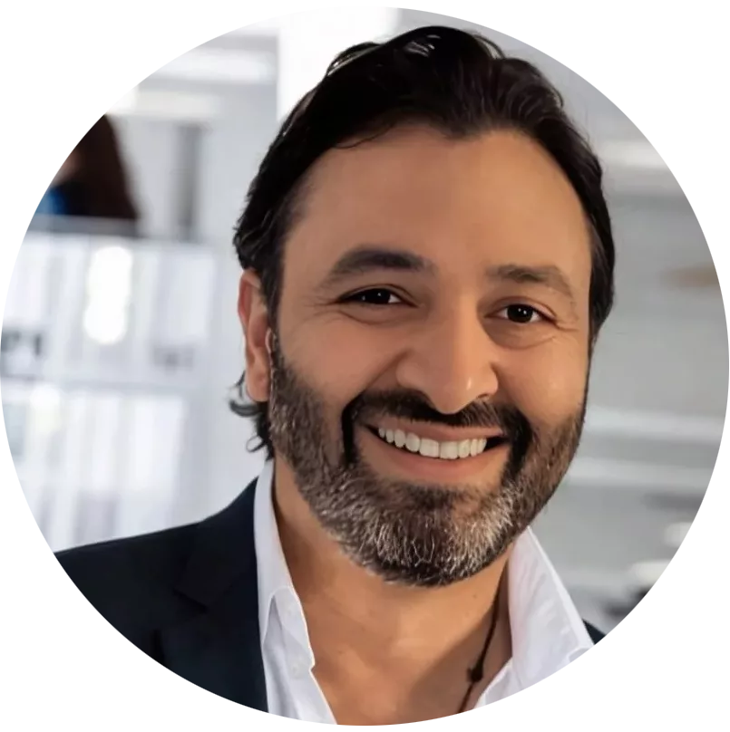 Salim Dhanji in the lab wearing a dark blazer and white dress shirt