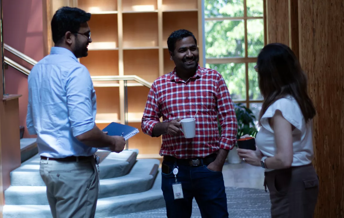 trio-out NanoVation team members socialize over coffee during a break